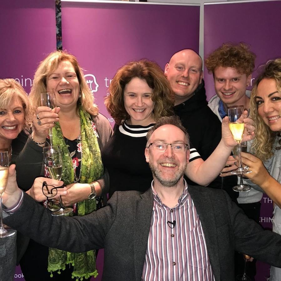 Graduates celebrating NLP Practitioner certification with Micheal Colhoun